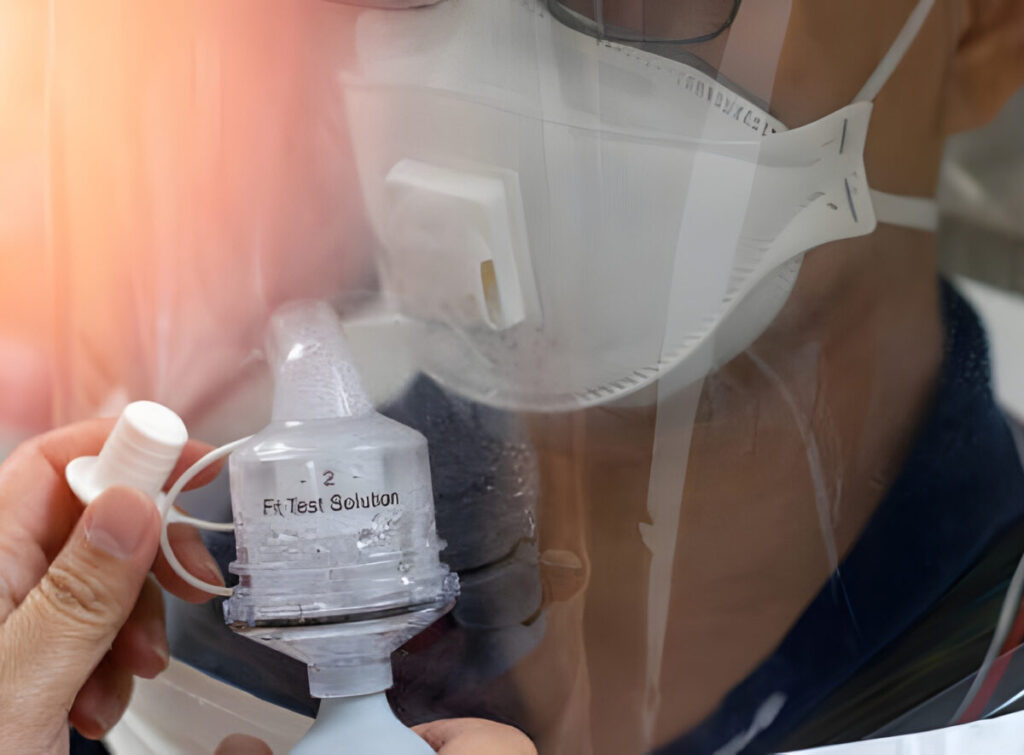 Technician conducting N95 respirator fit-test for asbestos safety