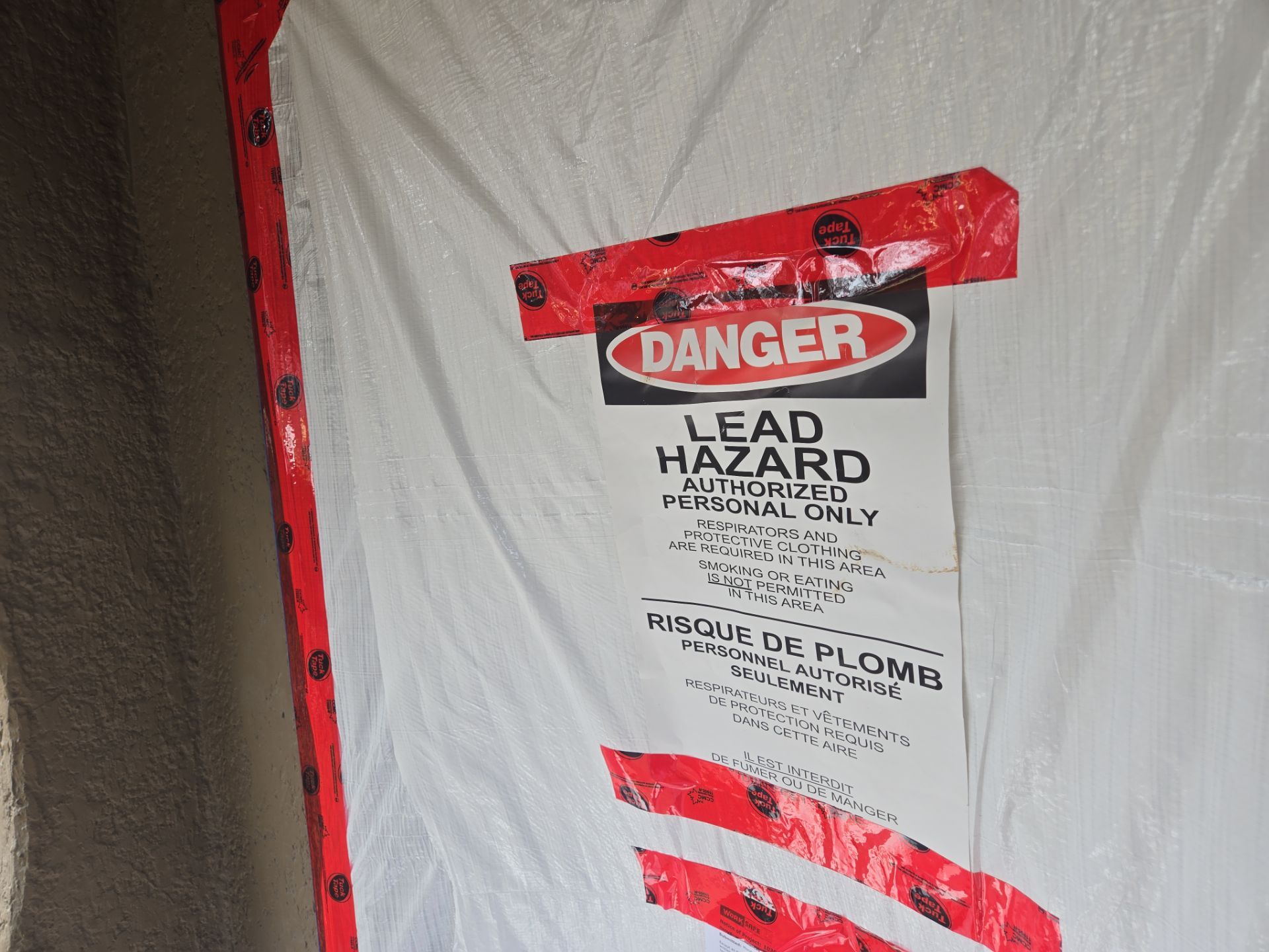 Certified environmental technician conducting hazardous materials inspection in building.